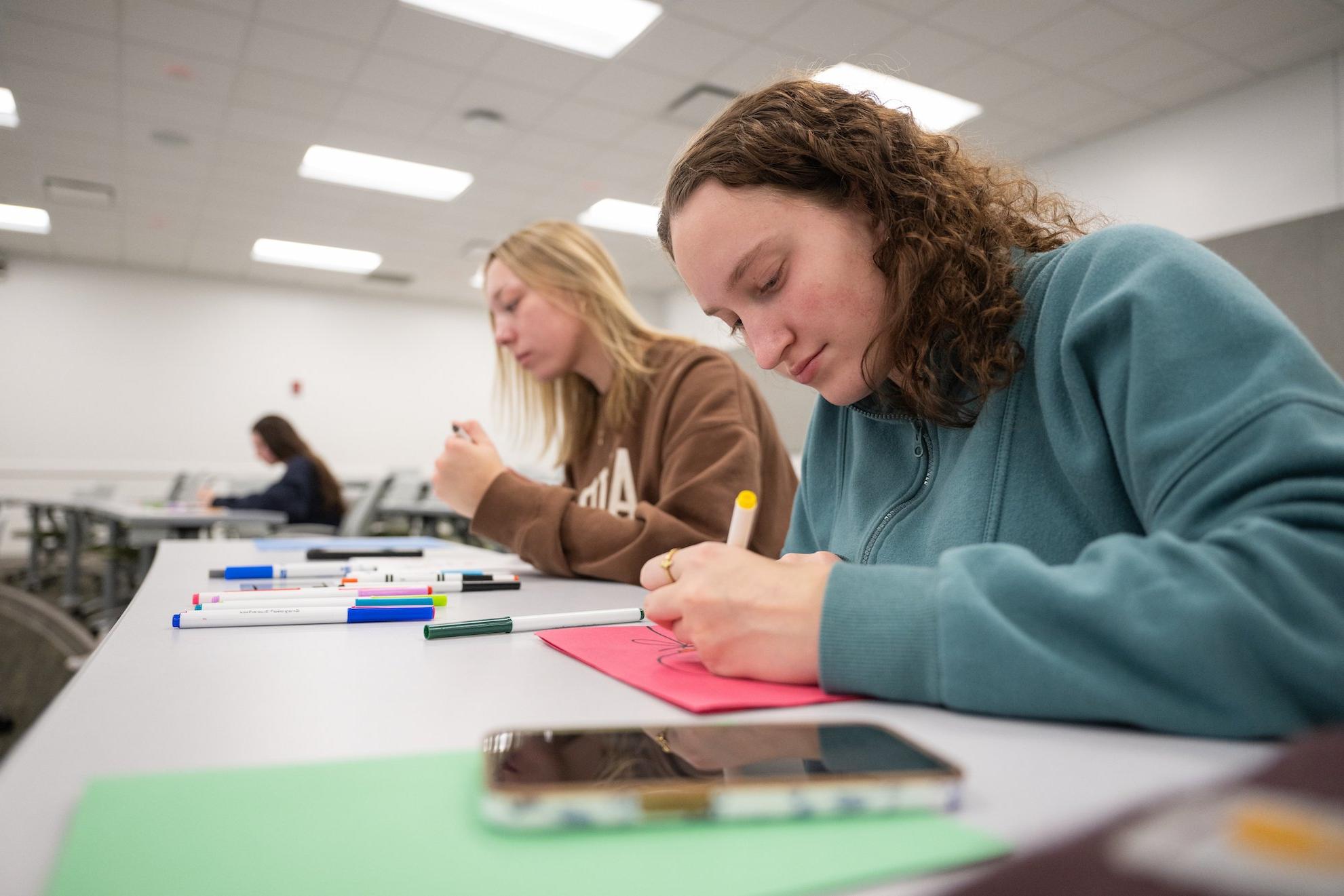 NDSU students writing letters to children